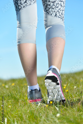 Young sports woman enjoys fitness and bright sunshine