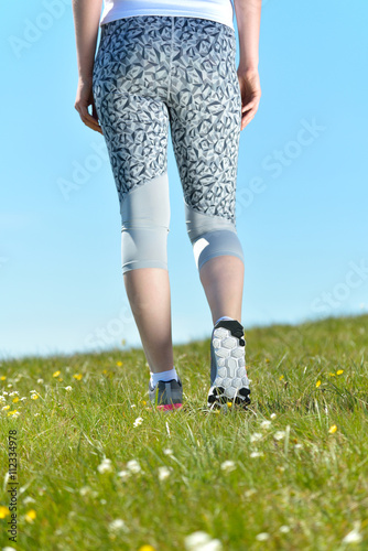 Young sports woman enjoys fitness and bright sunshine
