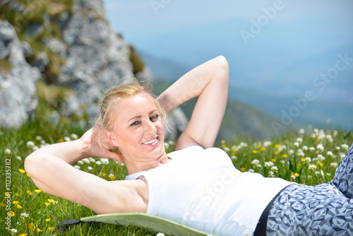 Young sports woman enjoys fitness and bright sunshine