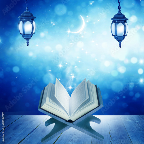 Eid Mubarak greeting background .Quran on a wooden book stand photo