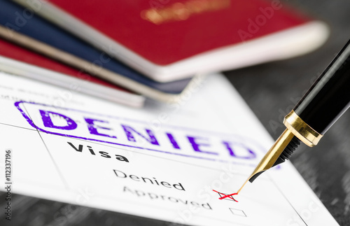 Photography Visa application denied, close up shot of a form, passports and pen