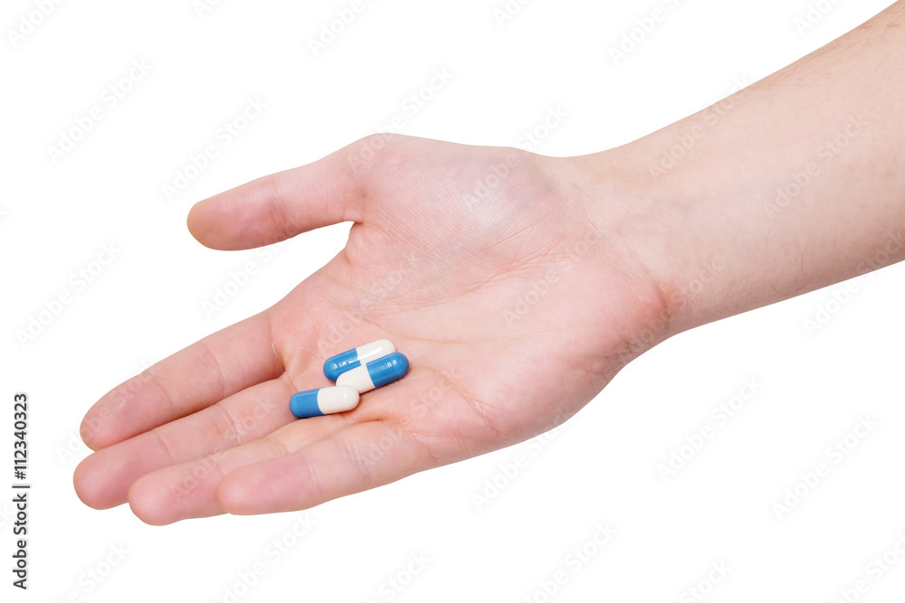 Medicine pills in hand on a white background Medicine pills in hand on a white background