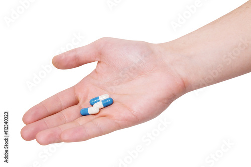Medicine pills in hand on a white background
