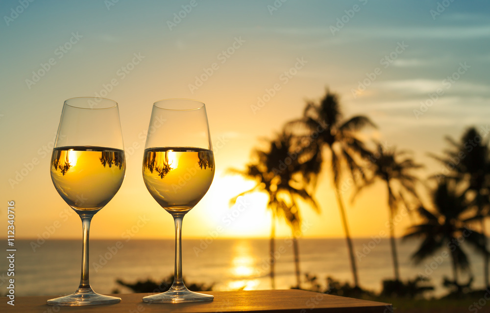 Vacation and relaxing holiday concept. Glass of wine and a beautiful sunset view.

