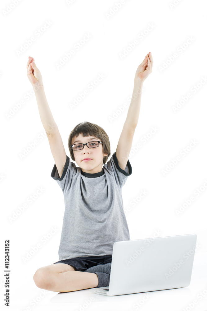 young boy with arms up in the air in grey t-shirt with laptop young boy with arms up in the air in grey t-shirt with laptop