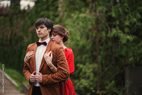 Couple hugging in love at park garden. Stylish man at velvet jac photo