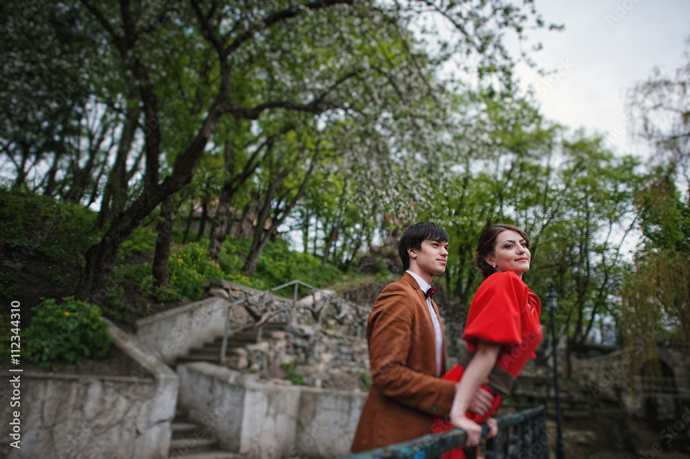 Couple hugging in love background barrier of cliff. Stylish man