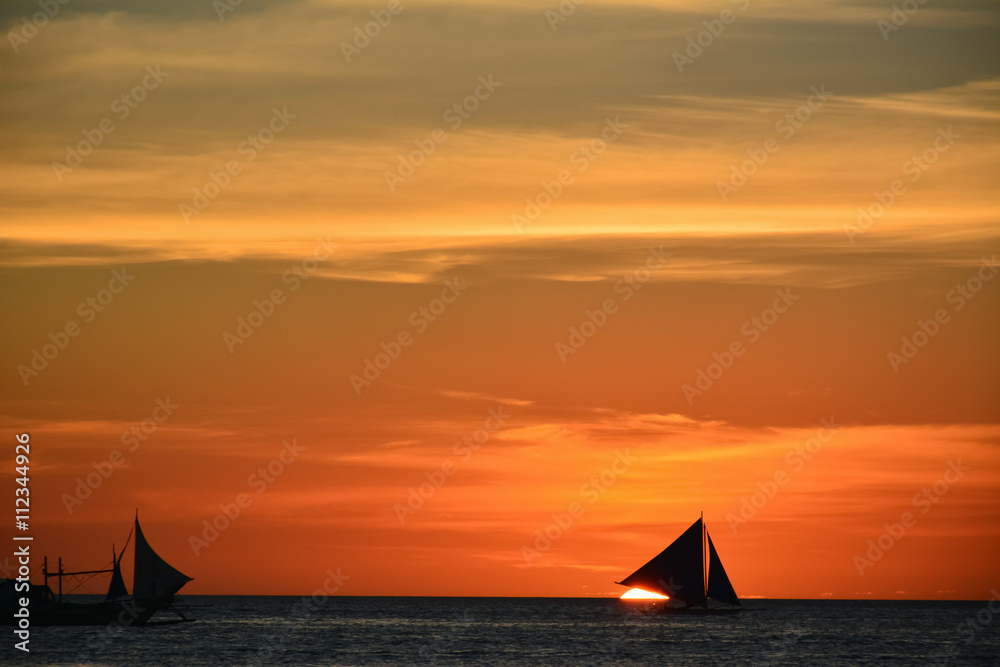 Sunset in Boracay, Philippines with a boat in the foreground