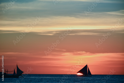 Sunset in Boracay, Philippines with a boat in the foreground