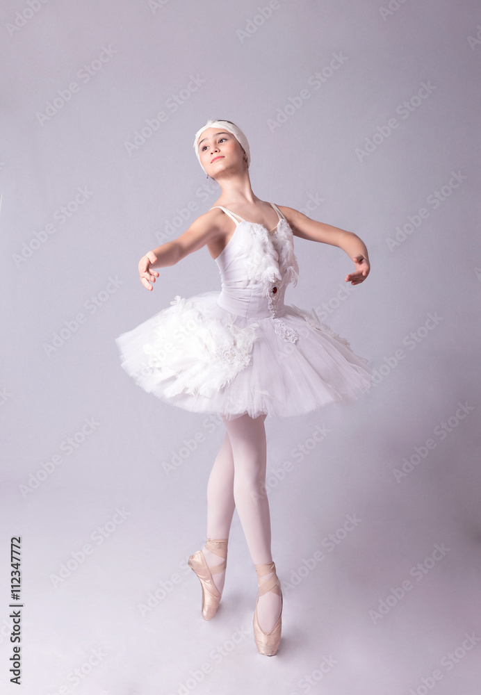 Naklejka premium Ballerina is dancing on a white background