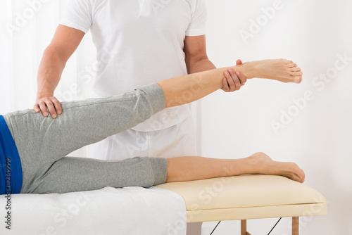 Therapist Giving Leg Massage To Woman © Andrey Popov