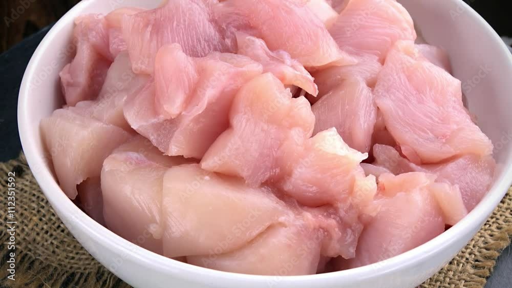 Portion of raw Chicken Fillet (chopped; not loopable; 4K) Portion of raw Chicken Fillet (chopped; not loopable; 4K)
