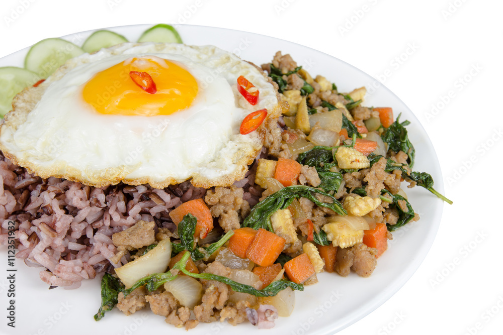 Fried egg with stir-fried minced pork and basil isolated on whi Fried egg with stir-fried minced pork and basil isolated on whi