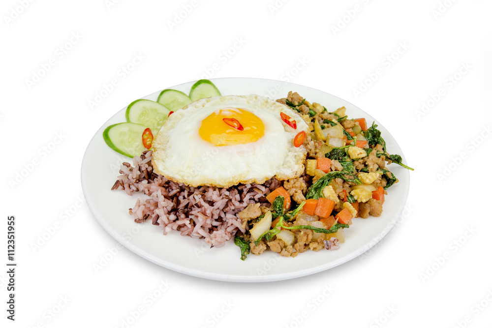 Fried egg with stir-fried minced pork and basil isolated on whi Fried egg with stir-fried minced pork and basil isolated on whi