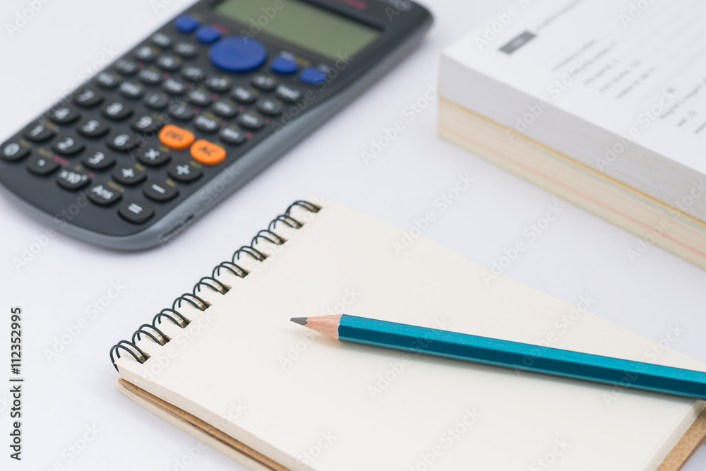 Blank notebook with calculator and pencil on white background Blank notebook with calculator and pencil on white background