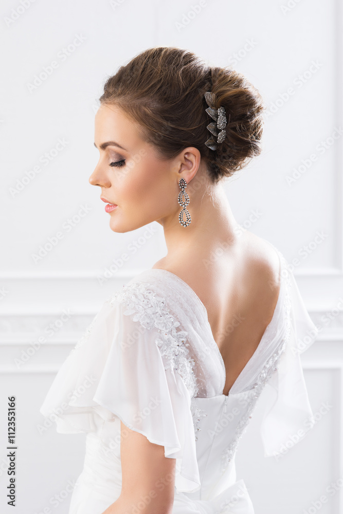 Back view of young and beautiful bride in white dress Back view of young and beautiful bride in white dress