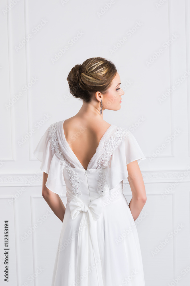Back view of young and beautiful bride in white dress Back view of young and beautiful bride in white dress