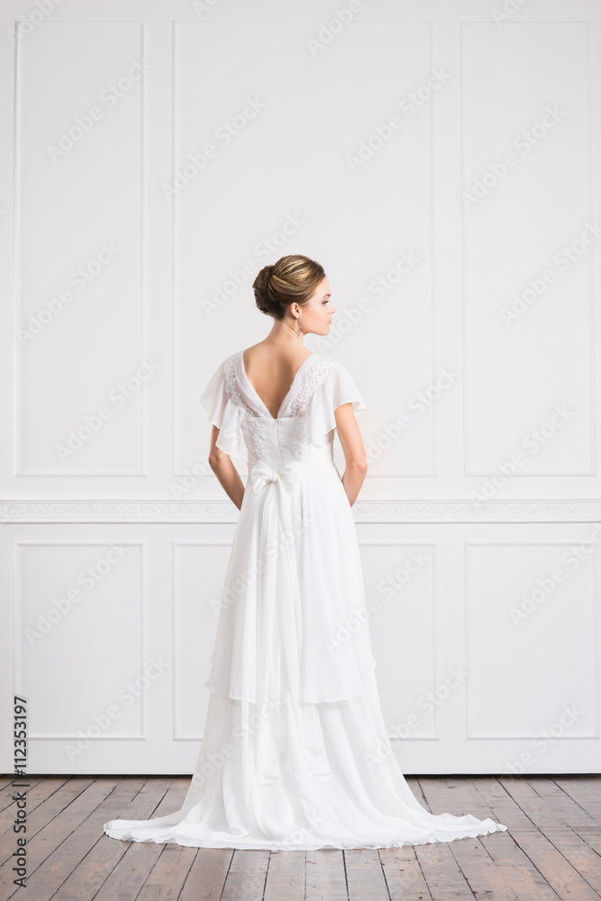 Back view of young and beautiful bride in white dress Back view of young and beautiful bride in white dress