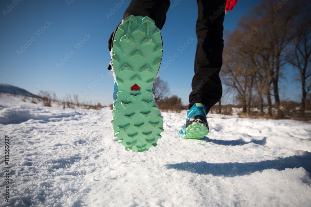 Running shoes close up. Legs runner closeup. Trail running on a snow-covered  winter trail. Motivation concept Stock Photo | Adobe Stock