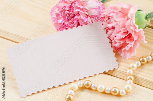 Blank white greeting card with pink Carnation flower.