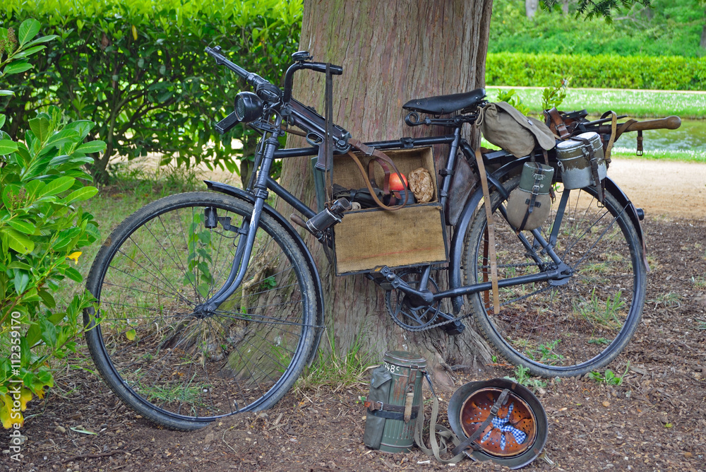 Vintage bicycle with World War 2 German Equipment Including Machine gun and Helmet.