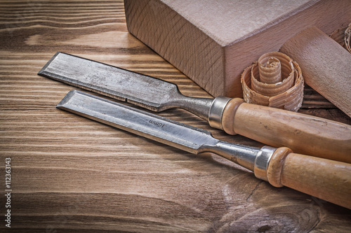 Lump hammer chisels curled scobs on vintage wood board construct