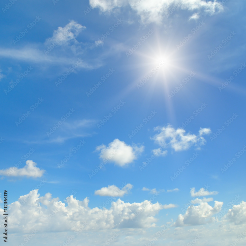 sun on blue sky with white clouds