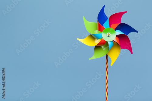 Colorful pinwheel isolated on blue background photo
