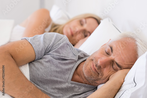 Couple sleeping in bed photo