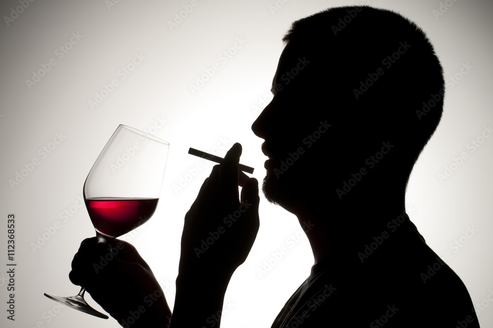 silhouette of a man smoking and drinking wine silhouette of a man smoking and drinking wine