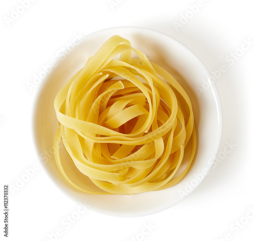 pasta in bowl isolated on white, from above