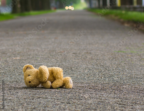 Teddy bear lies on the road