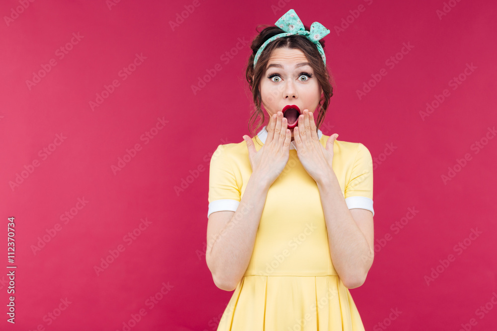 Wondered pinup girl in yellow dress with mouth opened Wondered pinup girl in yellow dress with mouth opened