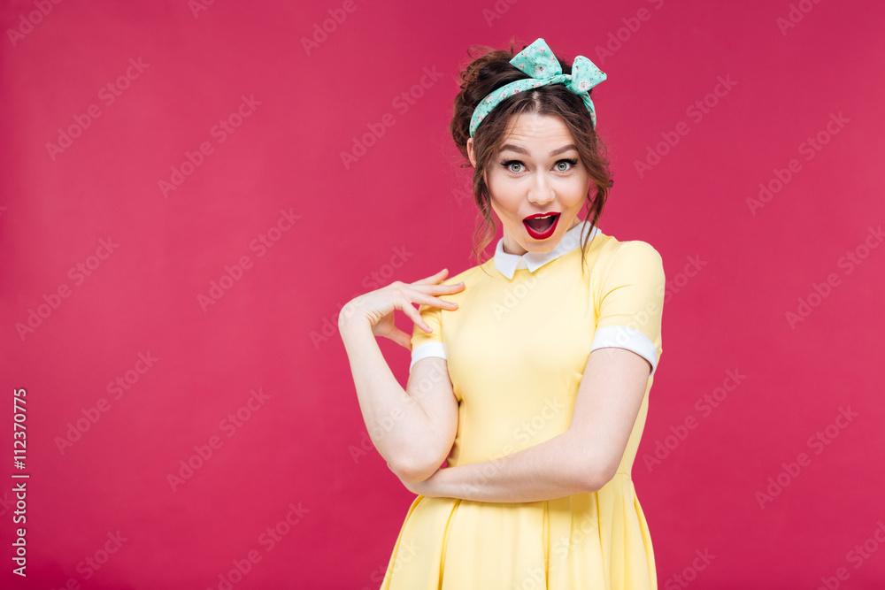 Amazed happy pinup girl in yellow dress Amazed happy pinup girl in yellow dress