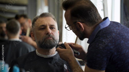 Stylish hair salon, barber Empozantny engaged beard respectable businessman.
