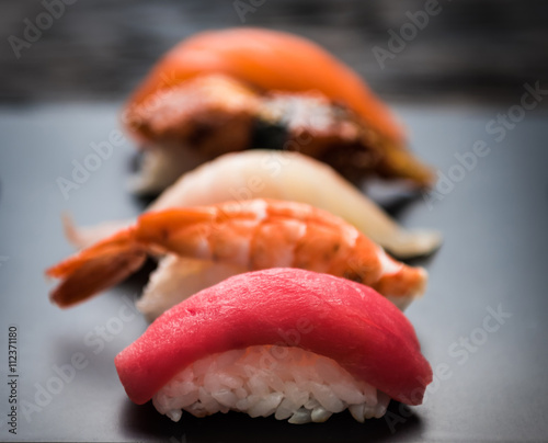 close up of sashimi sushi set on black tray