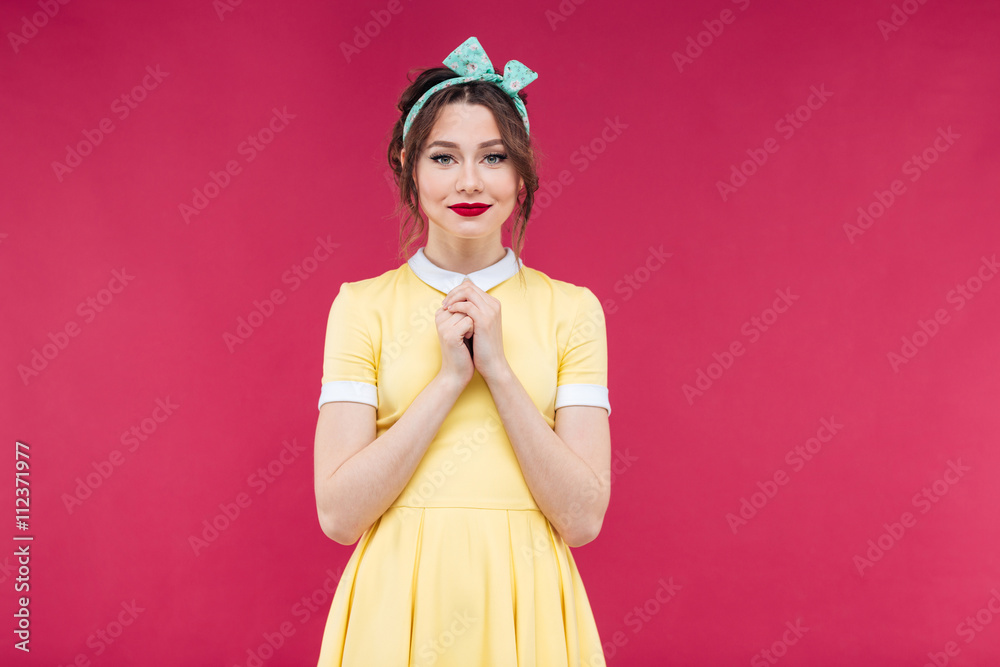 Attractive charming young woman in yellow dress standing Attractive charming young woman in yellow dress standing
