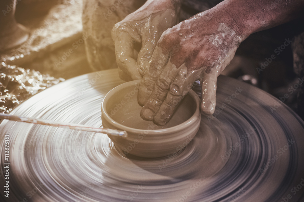 Potter makes on the pottery wheel clay pot. Potter makes on the pottery wheel clay pot.