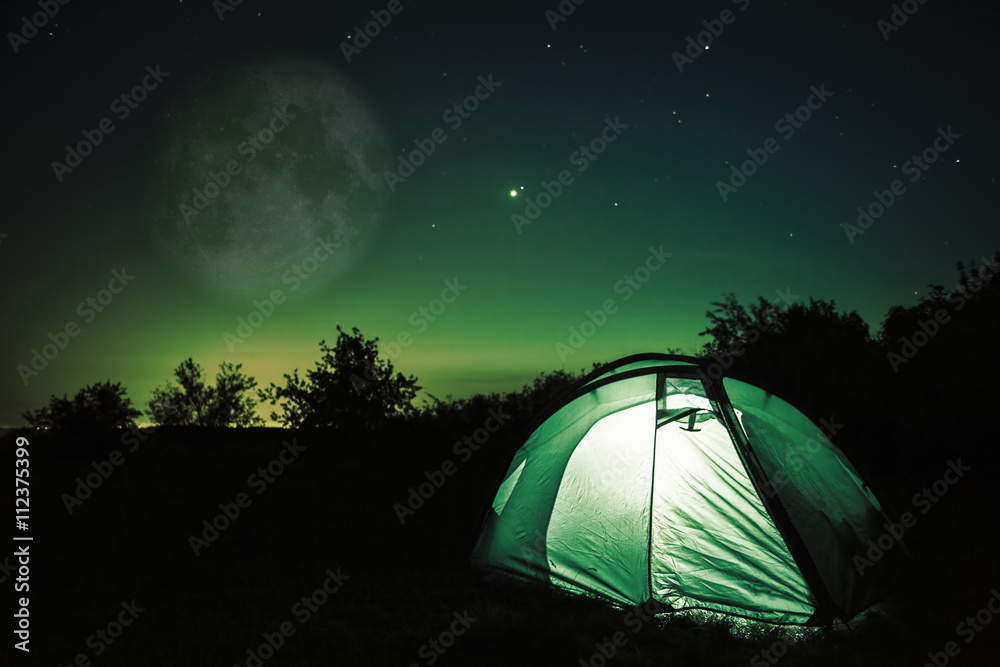 Tent under stars and moon