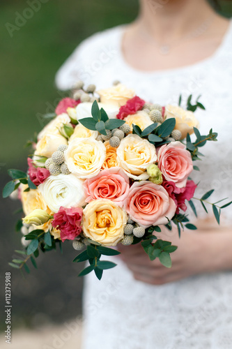 Bridal bouquet from yellowe and pink roses