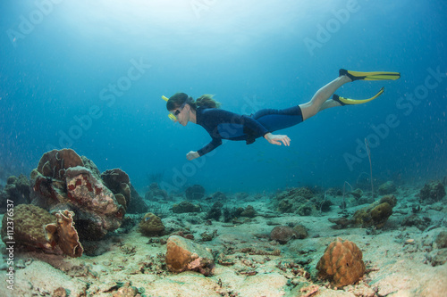 Lady the diver swims under water