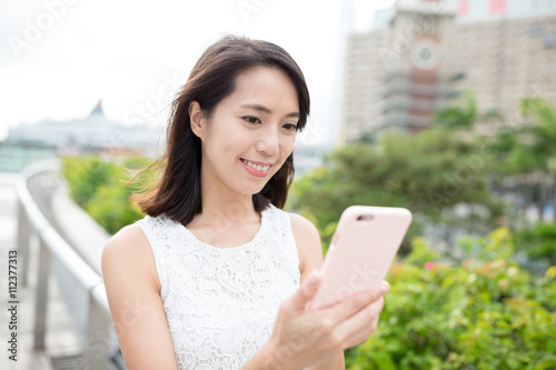 Free Download Woman use of cellphone at outdoor - GFXLoad