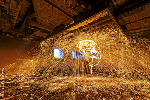 Burning Steel Wool spinning. Showers of glowing sparks from spin photo