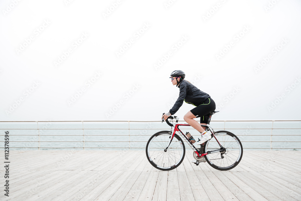 Fototapeta premium Woman riding on a bicycle outdoors