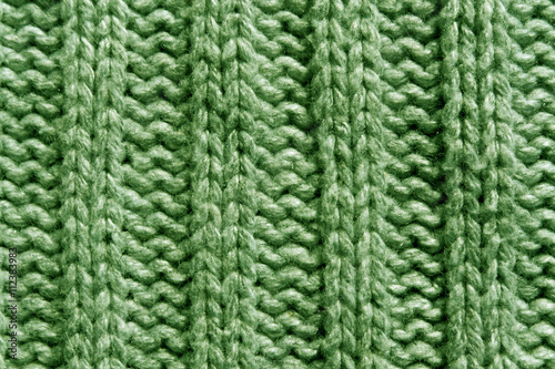 Abstract green knitting texture close-up.