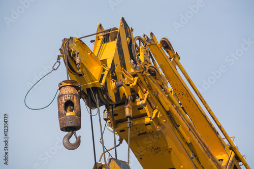 Yellow crane arm with hook close-up