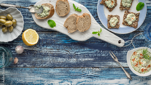 Bread with tzatziki on the blue wooden table with accessorize horizontal