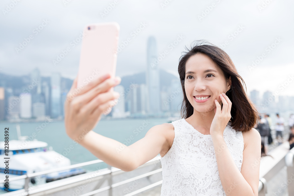 Woman using mobile phone for taking selfie Woman using mobile phone for taking selfie