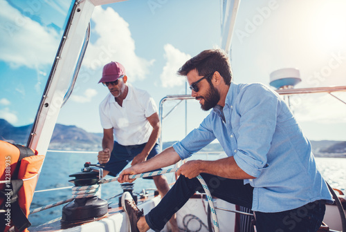 Father and son sailing on a summer day photo