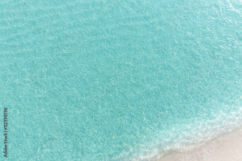 Close up blue sea water waves on white sand beach,Beautiful blue sea beach with white sand, Beautiful blue ocean beach close up shot, Clean beach with blue sea in Thailand